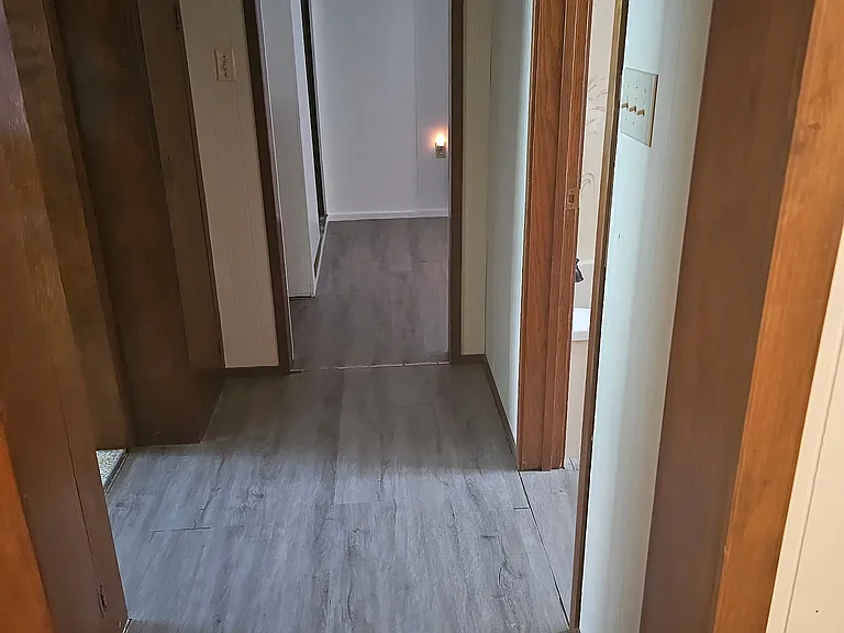 Hallway between bedrooms and bathroom. Storage/pantry built in storage in this area