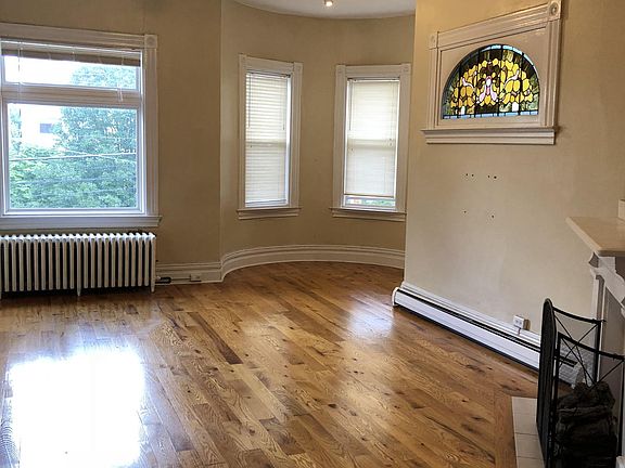 Large living room with fireplace and hardwood floors