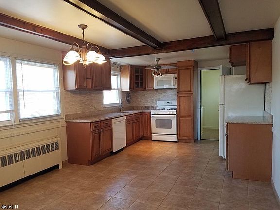 Large Updated Eat-In Kitchen with Back Door to Private Laundry Room and access to the Yard.