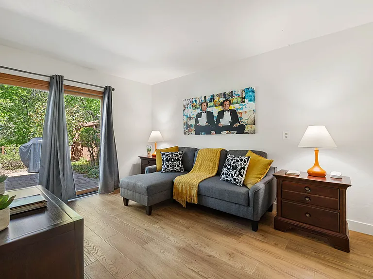 Bedroom 3 features a double sofa bed with direct access to the backyard, offering peaceful views and easy trail access.
