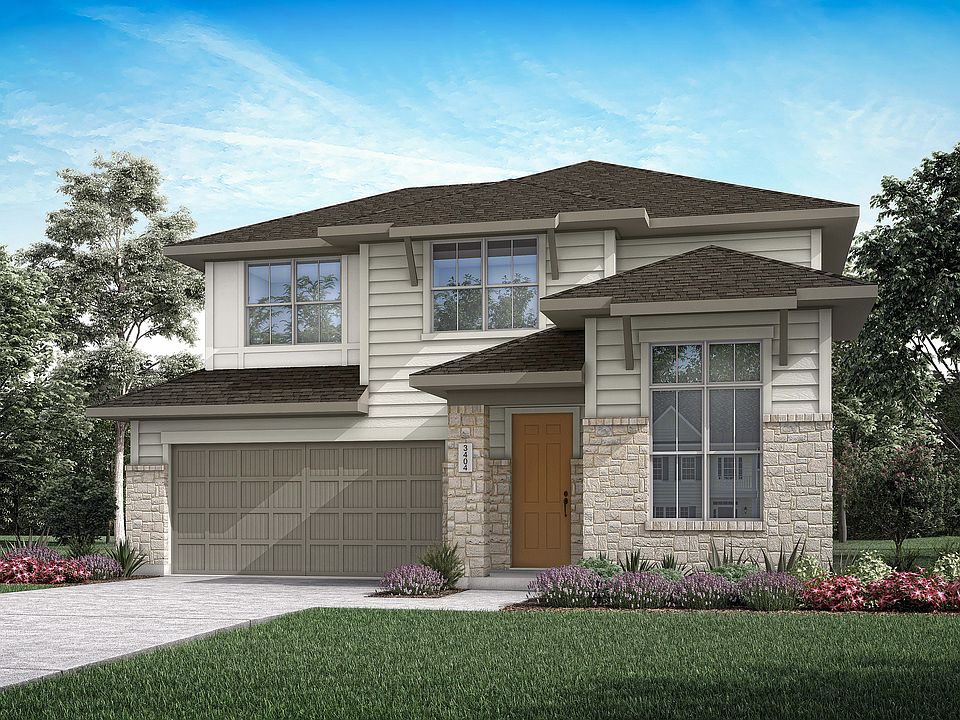 A two-story residential house with a garage, surrounded by lush greenery and a well-manicured lawn i