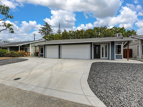 Front of duplex showing drive way, entry and two car garage
