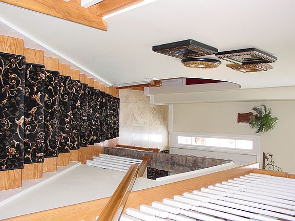 Hardwood Staircase w/ new carpet runner.