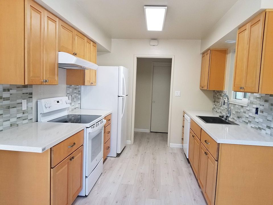 new kitchen: cabinets, appliances, quartz counter, same laminate floor throughout