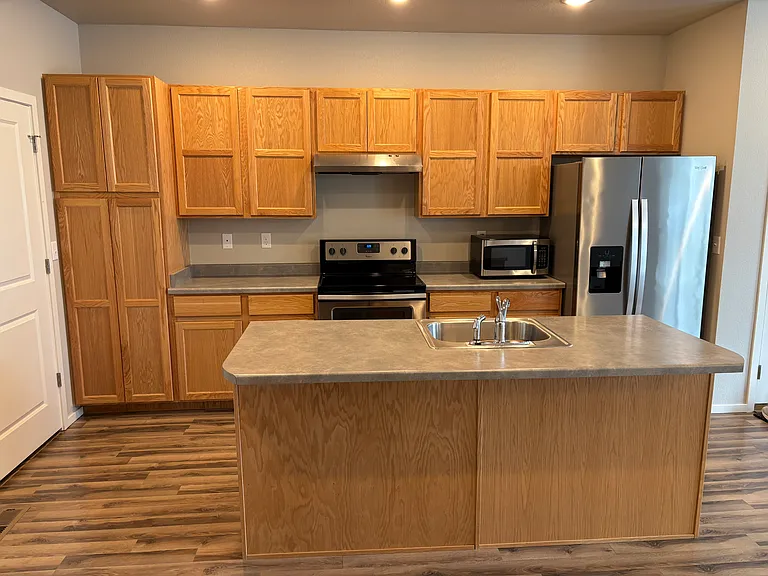 Exceptional wood cabinet space, convenient Island and like-new appliances.