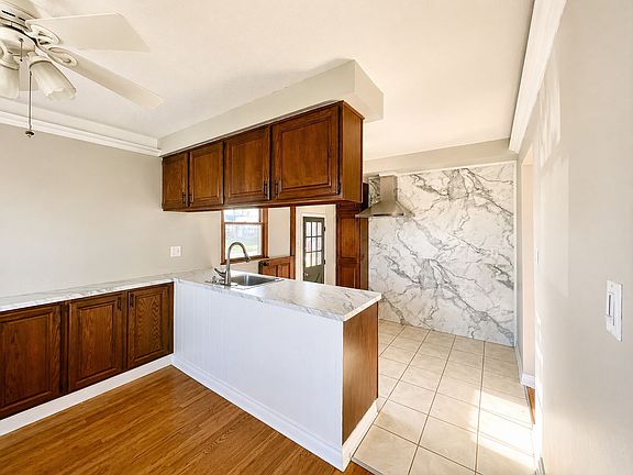 Dining room looking into kitchen. Cabinets open from both sides