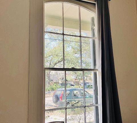 One of the two floor to ceiling windows in the living room