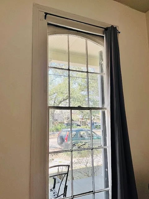 One of the two floor to ceiling windows in the living room