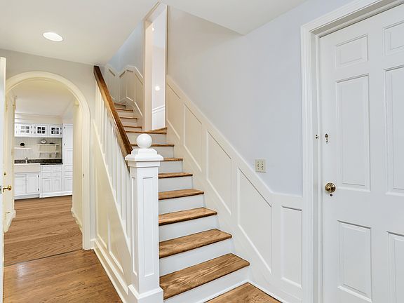 Virtually modified white cabinets; hardwood floors