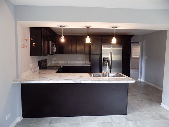 Kitchen has Granite Countertops, Stainless Steel Appliances, Breakfast bar and plenty of Cabinets.