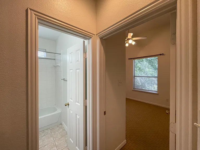 guest/hall bath and carpeted back bedroom
