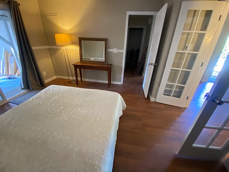 Bedroom lealding to backyard and living room.