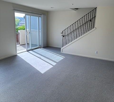 living room with sliding glass door to balcony area