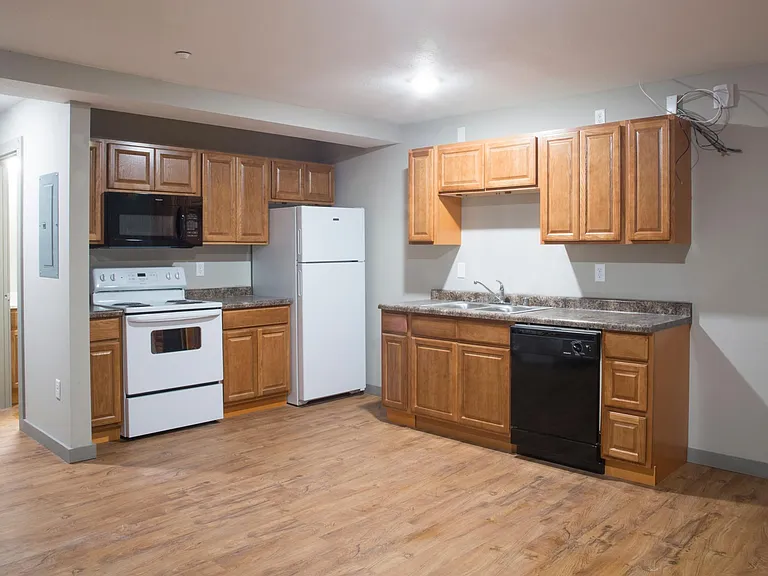 Studio apartment with full kitchen and appliances.