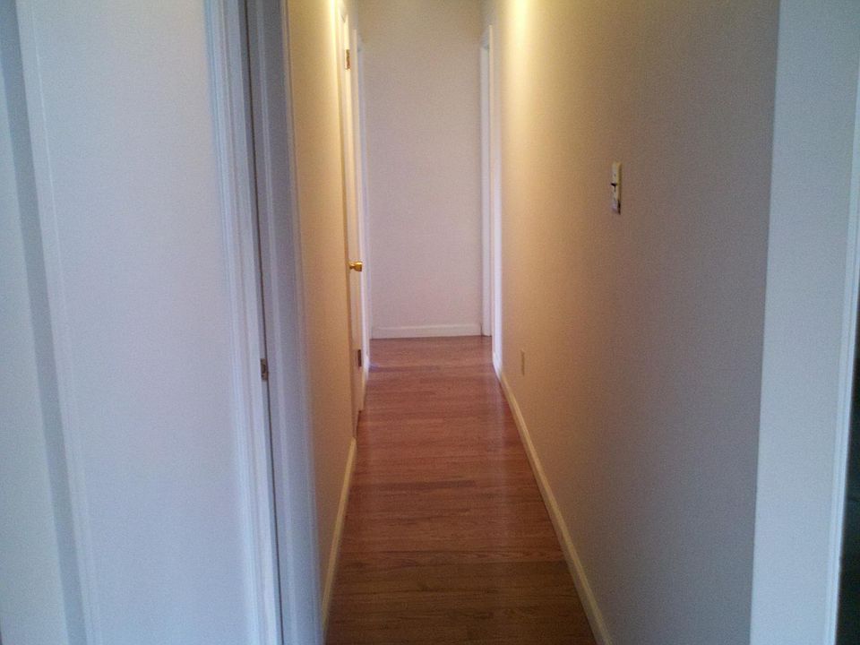 Hallway leading to bedroom # 2 with 1/2 bath and bedroom/computer room #3.