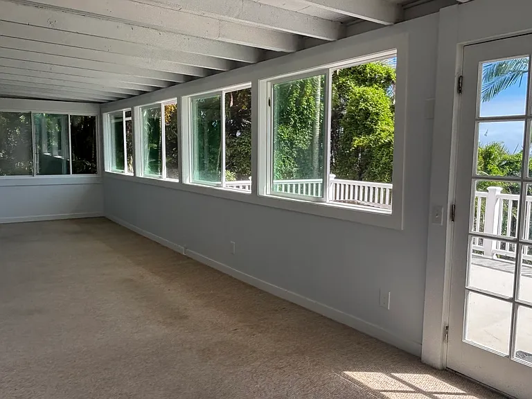 Livingroom is large spacious area with new windows that share the fresh air and that frame the ocean views below.