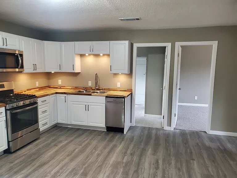 Kitchen and door to large bathroom and bedroom one