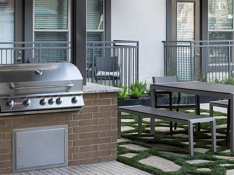 Outdoor grilling station with built in BBQ grills and dining tables.