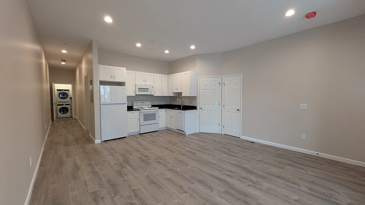 Huge living/dining room with a coat closet in the entry way that leads to a brand new kitchen with high-efficiency appliances (refrigerator, stove/oven, dishwasher, microwave) - 464 Race St #2