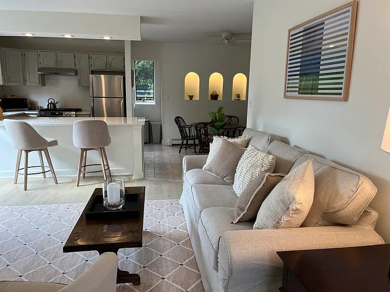 There's plenty of seating in living/dining/kitchen area with new 3 seat couch, club chair and swivel counter stools. New wide plank oak luxury vinyl floors.