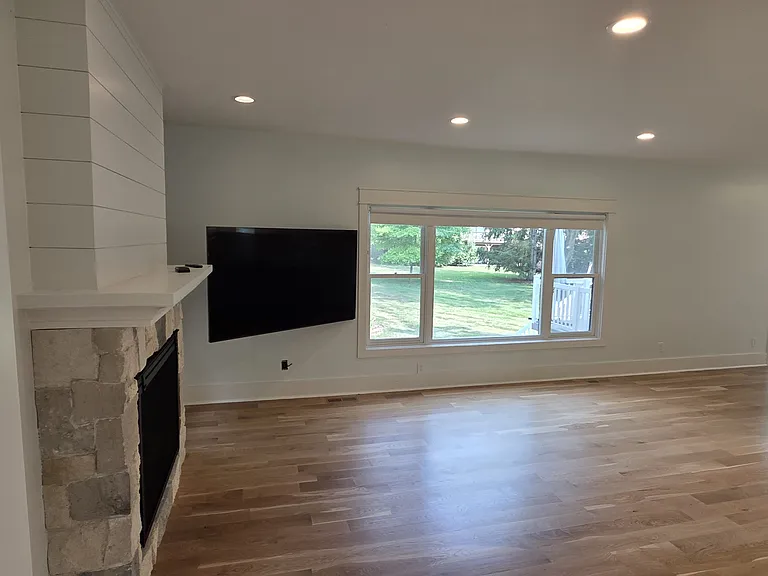 Living room showing gas fire place with real stone.