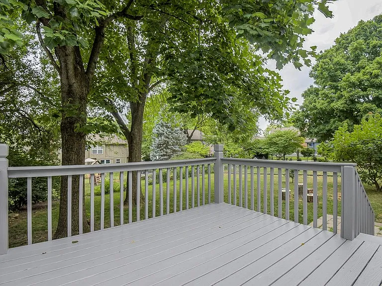The deck offers a quiet oasis in the lush backyard, immediately off the kitchen.