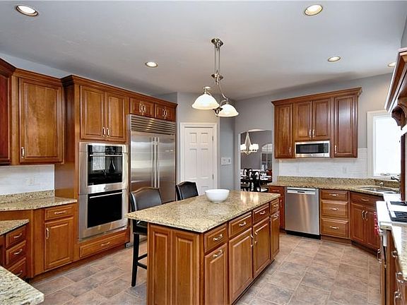 Fresh paint and new back splash enhance this spacious chef's center island kitchen. Newer professional grade stainless appliance