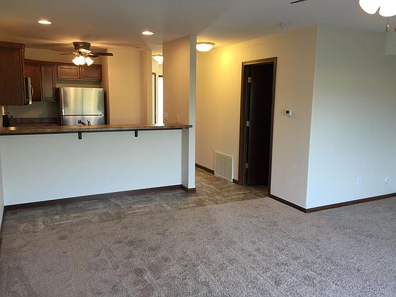 Kitchen, bar, and living room area