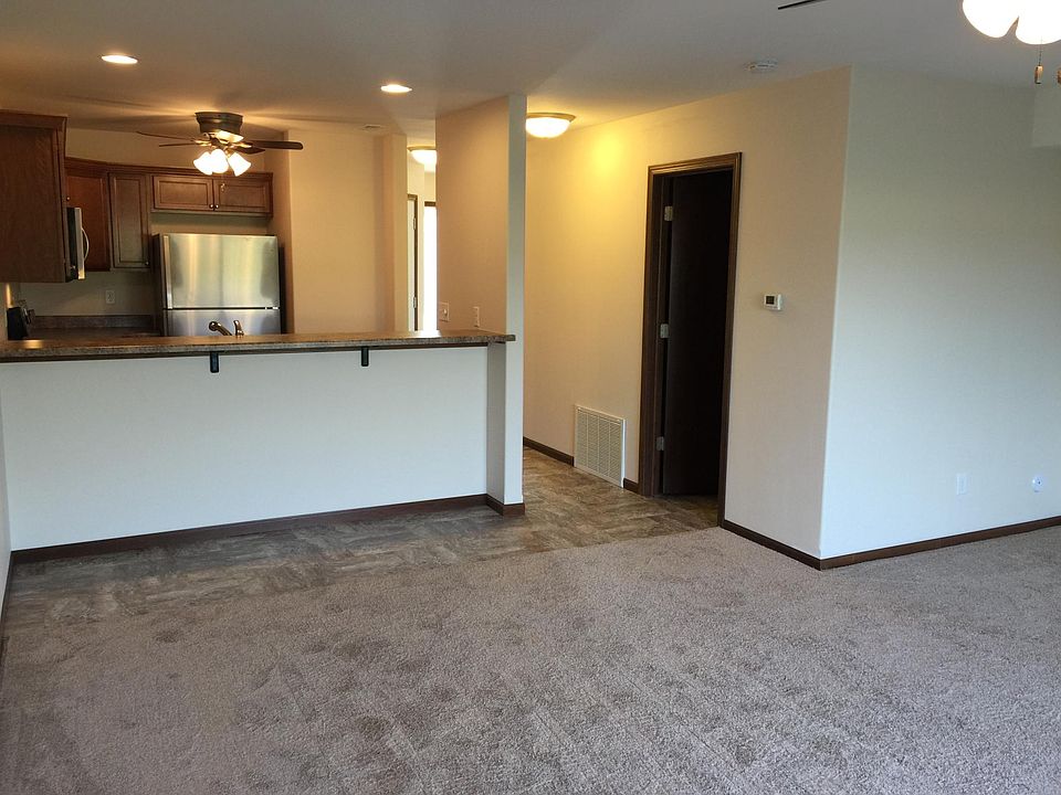 Kitchen, bar, and living room area