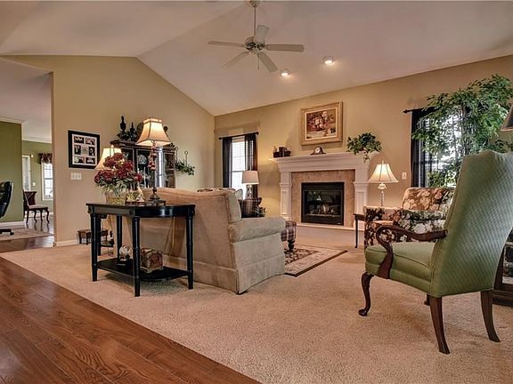 You are Greeted in the Entry by Cherry Hardwood Floors, Gas Fireplace and Vaulted Ceilings in the Living Rm.