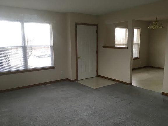 Living room, front door, and part of dining area