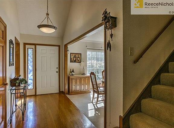 Spacious entry features gleaming hardwood floors.