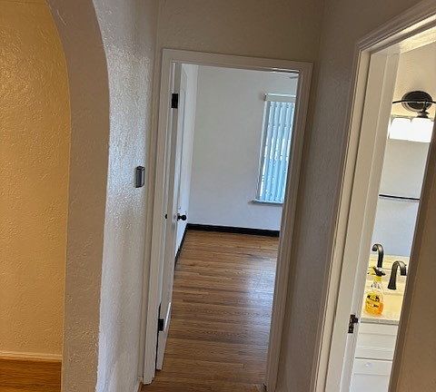 Hallway view showing dining room on left, bathroom on right, and master bedroom straight ahead