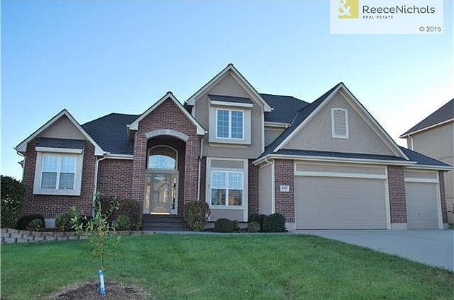 Gorgeous Front Elevation.  Former Model was dressed up with all the bells and whistles.  Note all of the brick in front.   All Brick and Stucco front with excellent landscaping.  Expensive Pavestone wall.
