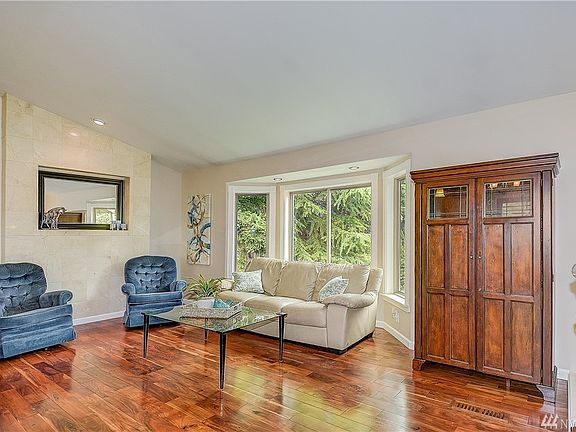 Upstairs family room with vaulted ceilings, bay window & Acacia hardwood floors. 