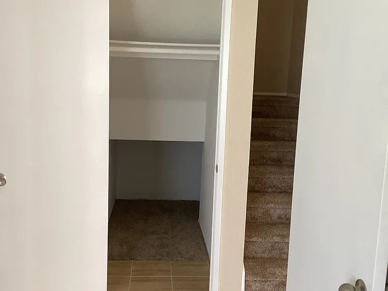 Coat closet and additional under stairs storage.