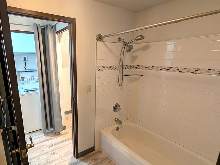 Downstairs bathroom opens to the hall and the primary bedroom.