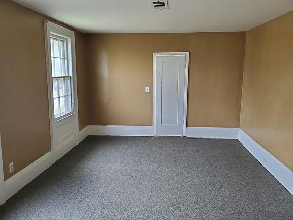 New carpeting, Bed #2 of 2. Lots of light with S facing windows. Walk in closet beyond the old door.