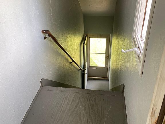 Covered interior steps with steel door at the top and bottom with deadbolts on both. Keyed alike.