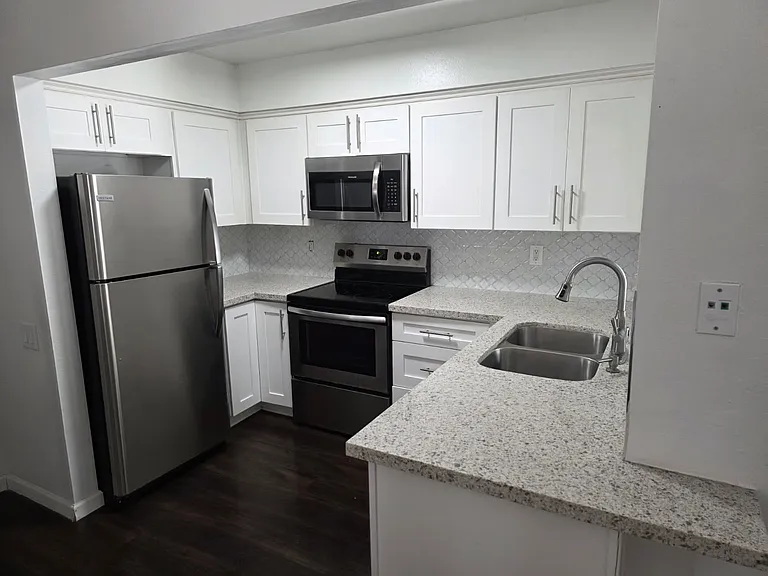 Full-size kitchen with stainless steel appliances and ample cabinet storage.