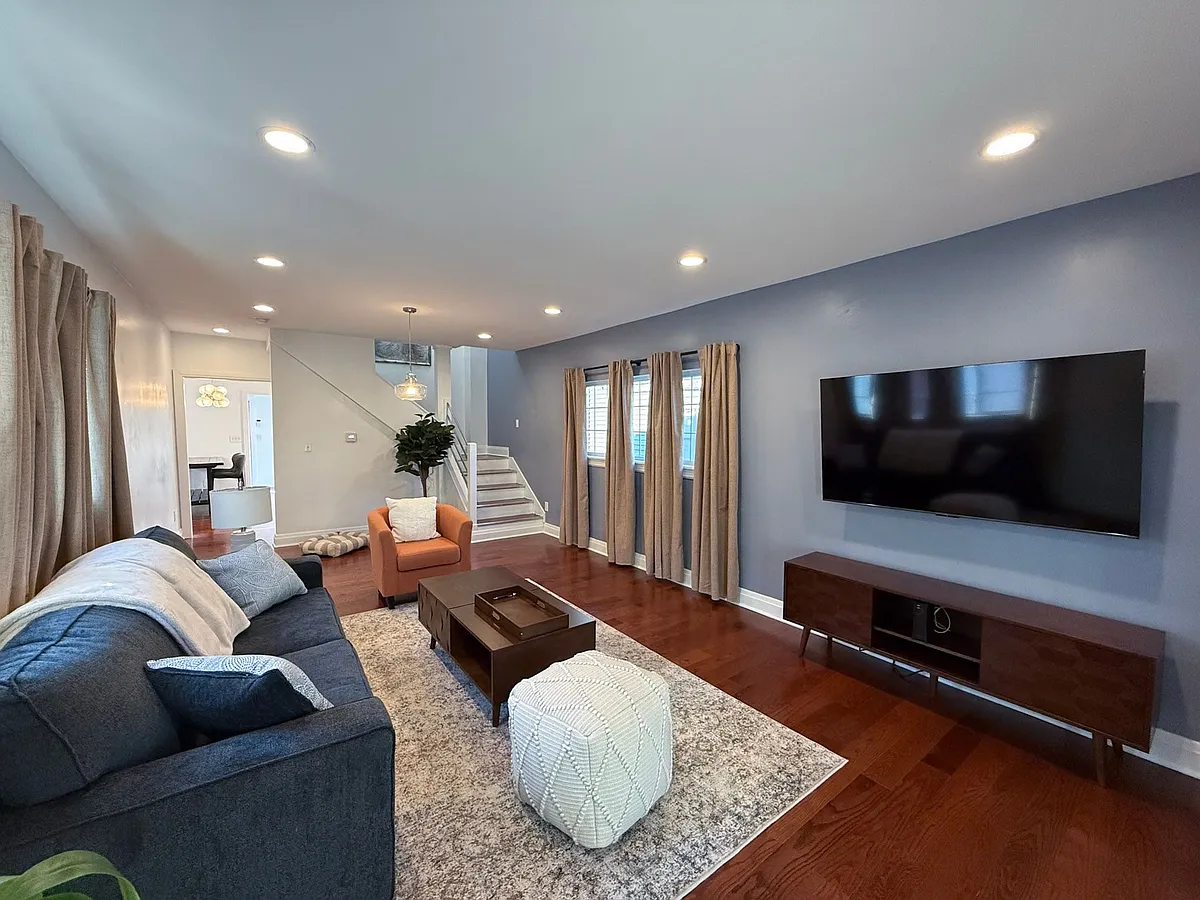 Comfortable living area with new couch and 65" flat screen TV. - 234 N Reisner St