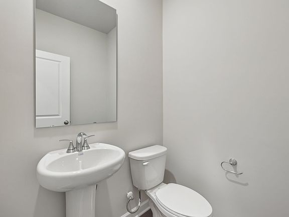 The half bathroom is conveniently located on the first floor for guests.