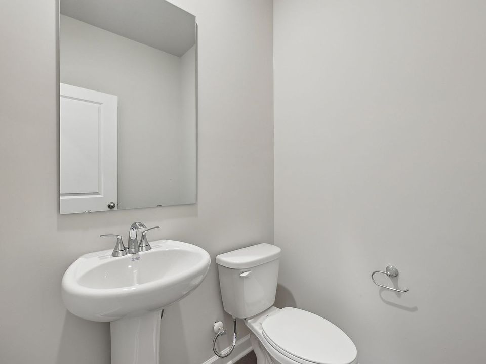 The half bathroom is conveniently located on the first floor for guests.