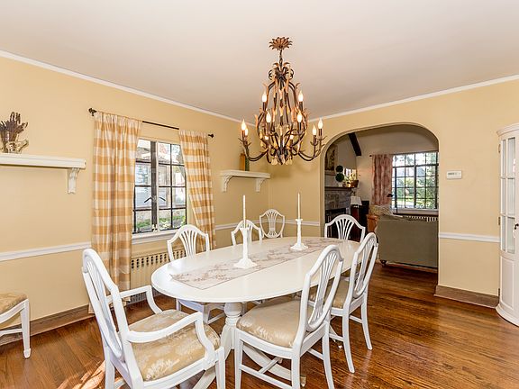 Formal dining room adjoins the living room. Dining Room is bathed in sunlight from 2 large windows. Decorative chair rail molding and gentle crown molding completes this inviting space. Pristine wood floors and floorboards and stained dark to accentuate 