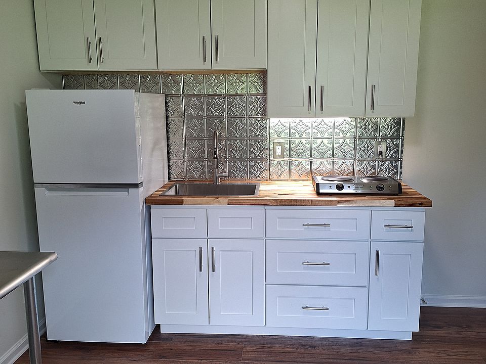Kitchen with 2 burner cooktop, large sink and new kitchen cabinets.