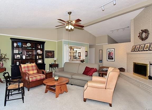 Vaulted Great Room is open to Entry.  Attractive Granite Wet Bar with mirrors behind shelves.