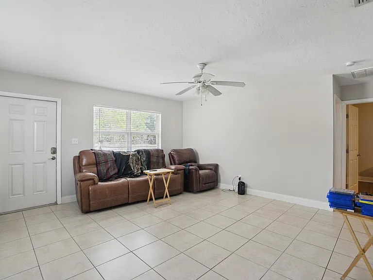 The living room boasts an open-concept design with luxury vinyl plank flooring, plenty of natural light, and seamless flow into the kitchen and dining areas. *Furniture not included*