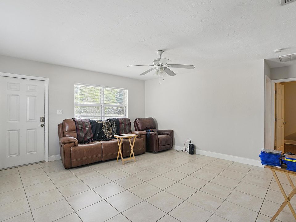 The living room boasts an open-concept design with luxury vinyl plank flooring, plenty of natural light, and seamless flow into the kitchen and dining areas. *Furniture not included*