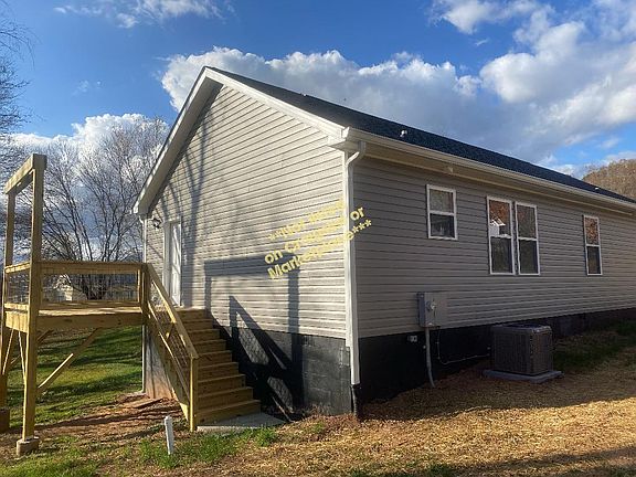 back of house with deck