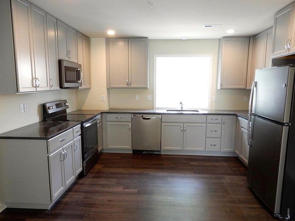 Large kitchen with GE stainless steel appliance with granite counter tops